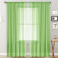 Green sheer voile curtain panel with rod pocket, light-filtering window-grid pattern