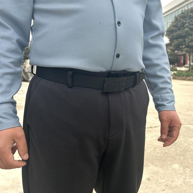 Black automatic buckle belt worn on men’s waist with matte buckle