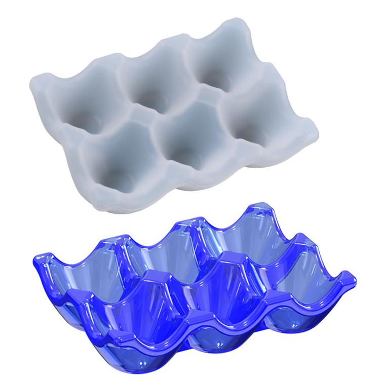 Light gray and blue silicone egg tray molds with 6 egg-cup cavities.