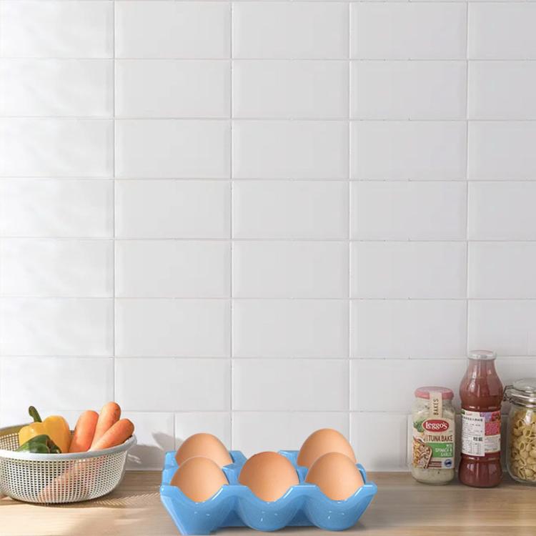 Blue silicone egg tray mold with eggs resting in the cups.