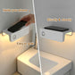 White motion-sensor nightlight sconce holding a smartphone on the top ledge