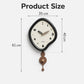 Irregular pendulum wall clock, black frame with cream dial and bronze-brown pendulum