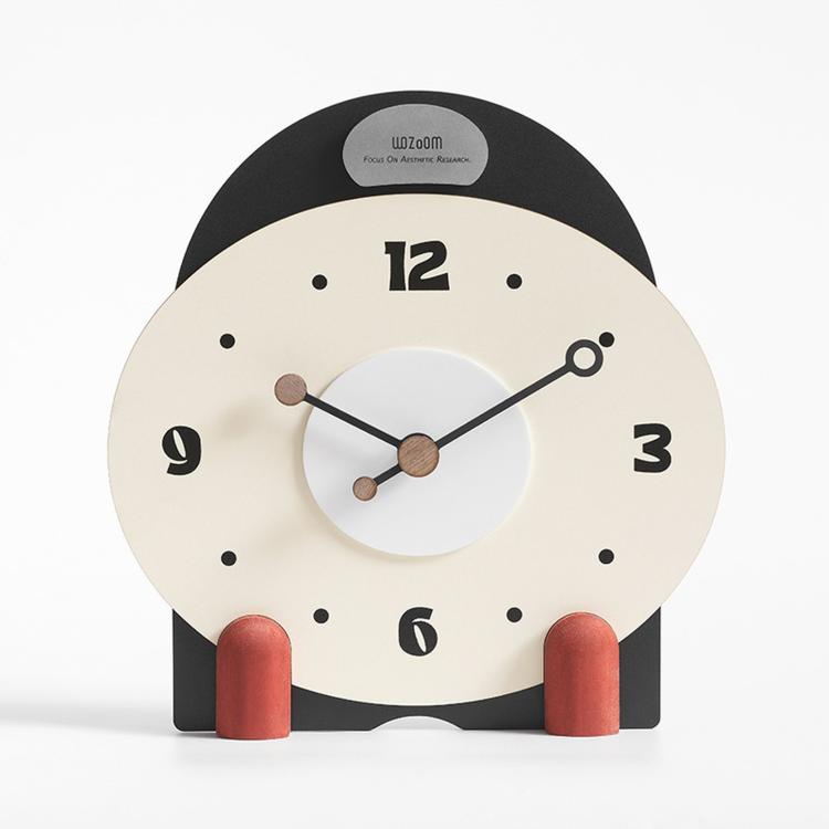 Small mantel table clock with cream face, black frame, and red side pegs