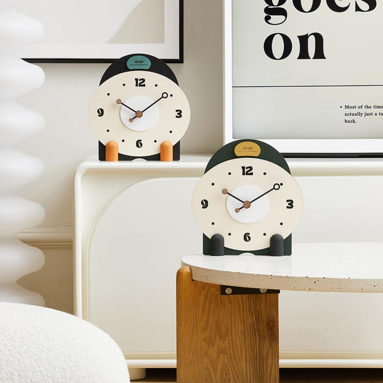 Small mantel table clock with cream dial, dark green top, and orange side pegs