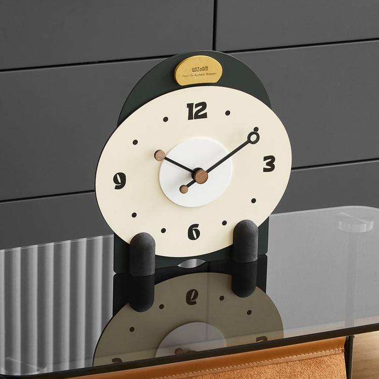 Small mantel table clock with cream face, black top, and dark side pegs