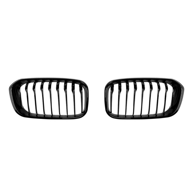 Black oval front grille pair with vertical slats and single-line center bars