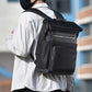 Black laptop backpack worn on shoulder, front organizer pocket with zippers