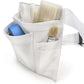 White tool pouch with front pockets holding paint brushes and small accessories.