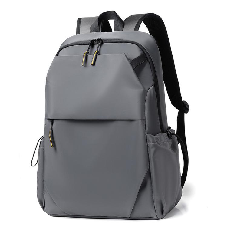 Slim gray laptop backpack with front flap, zip pockets, and padded shoulder straps.