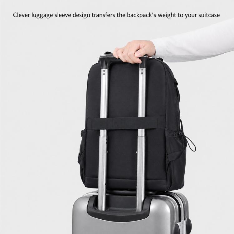 Black backpack with luggage pass-through strap for rolling suitcase handles.