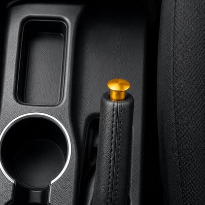 Aluminum alloy handbrake release button cover, gold cap with black leather-wrapped grip.