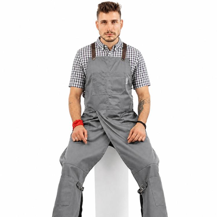Gray utility work apron with adjustable straps and split-leg legs with pockets.