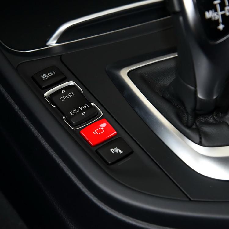 Red rear camera switch button installed beside other center console buttons