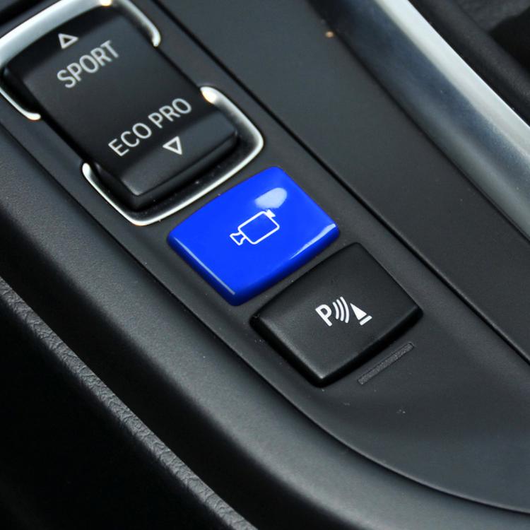 Blue rear camera switch button with white outline icon on console panel