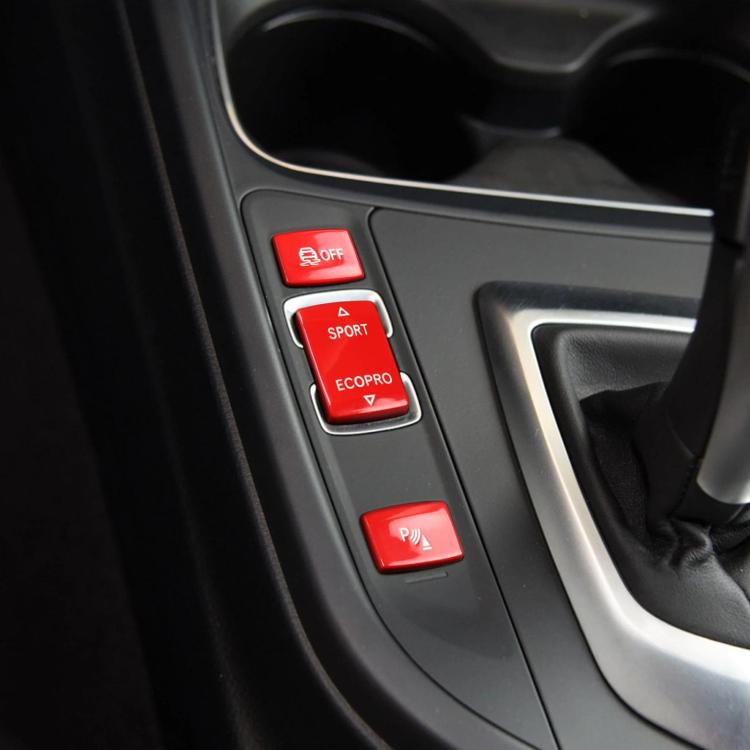 Red chassis gear button set on car console trim: OFF, SPORT, ECOPRO, P buttons
