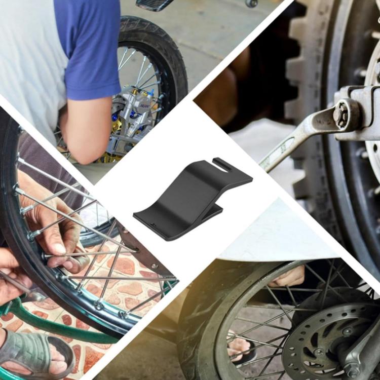 Black motorcycle tire bead installation bracket in use near motorcycle wheel