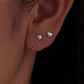 Silver-tone star and heart charm hoop earrings worn on ear
