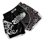 Muay Thai boxing shorts in black with white swirl graphic and floral-pattern side panel.