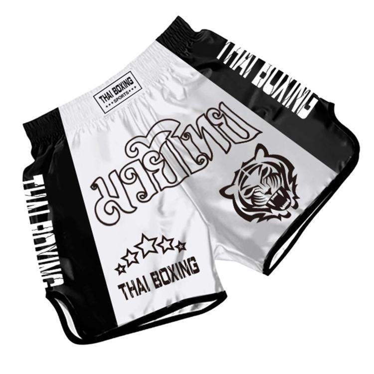 Muay Thai boxing shorts in white and black with Thai Boxing text and rose emblem.