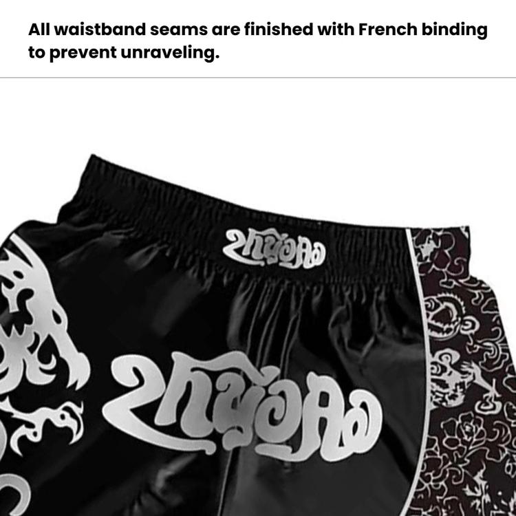 Black sanda fighting shorts with elastic waist and curved patterned graphic panel