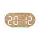 Digital alarm clock in oval light wood case with amber time digits and day-of-week text