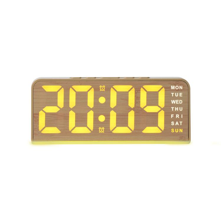 Digital alarm clock in light wood case with yellow time digits and warm yellow ambient bar