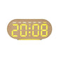 Digital alarm clock in oval light wood case with bright yellow time digits and weekday text