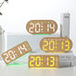 Digital alarm clock with multiple units shown, glowing amber and white time digits