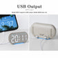 Digital alarm clock with LED time display, connected USB cable and blue backlight