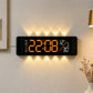 Curved digital LED wall clock with black frame, orange numbers and warm yellow ambient glow.