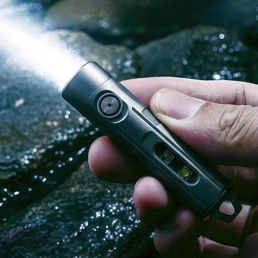 Dark gray rechargeable flashlight keychain with lanyard loop and side button