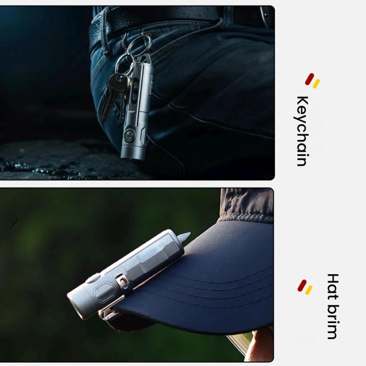 Gray flashlight keychain clipped to jeans pocket with metal keyring loop