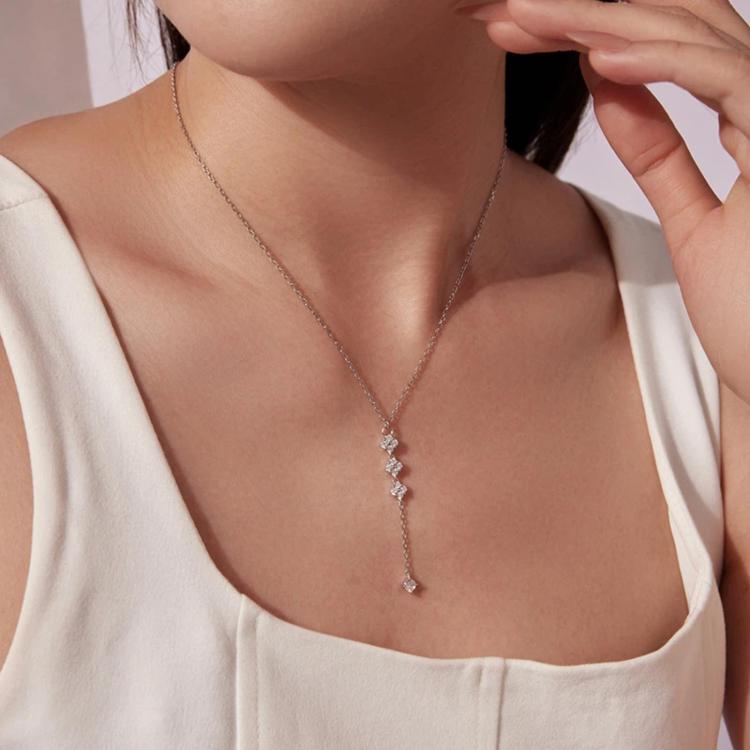 Four-leaf clover Y-necklace worn on collarbone with sparkling crystal drops