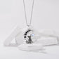 Silver-tone moon-cat pendant necklace with circular pendant and blue accent stone