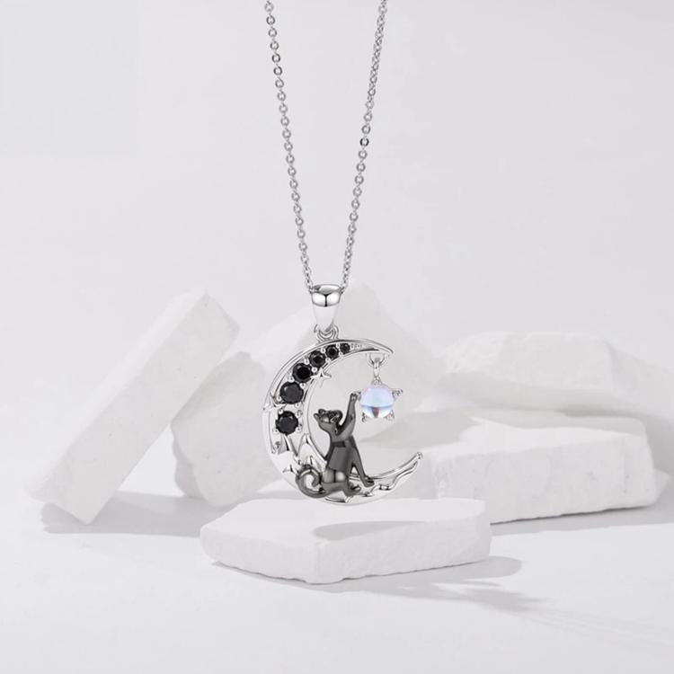 Silver-tone moon-cat pendant necklace with circular pendant and blue accent stone