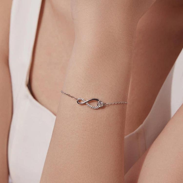 Sterling silver bracelet with infinity loop motif and oval center gemstone detail