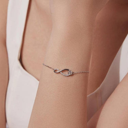 Sterling silver bracelet with infinity loop motif and oval center gemstone detail