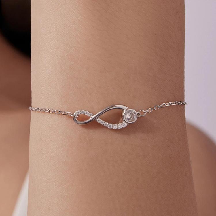 Sterling silver infinity loop bracelet with two round gemstone accents on chain
