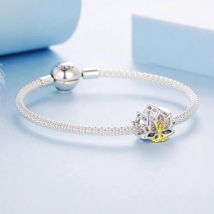 Silver bead bracelet with lotus yoga charm featuring seated figure in gold