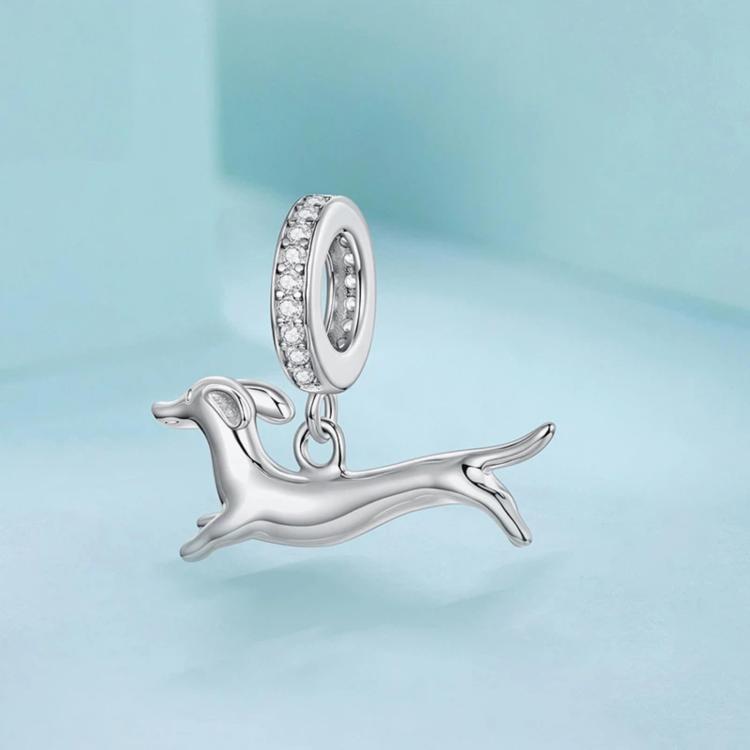 Running dachshund charm pendant hanging from a crystal-studded oval ring, silver-tone