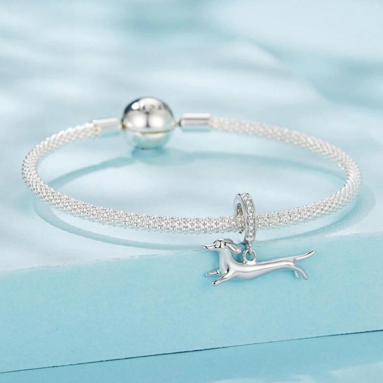 Sparkly mesh bracelet with a running dachshund charm and crystal hoop, silver-tone