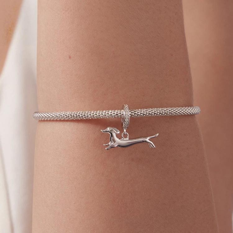 Running dachshund charm bracelet on wrist with mesh chain and crystal hoop, silver-tone