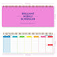 Pink undated weekly planner pad with gold spiral binding and colorful weekly schedule grid