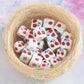 Cherry-pattern square ceramic beads in a nest, large-hole DIY jewelry accessory pack.