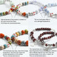 Beaded bracelets featuring square ceramic cherry beads with blue bow prints and metal spacers.