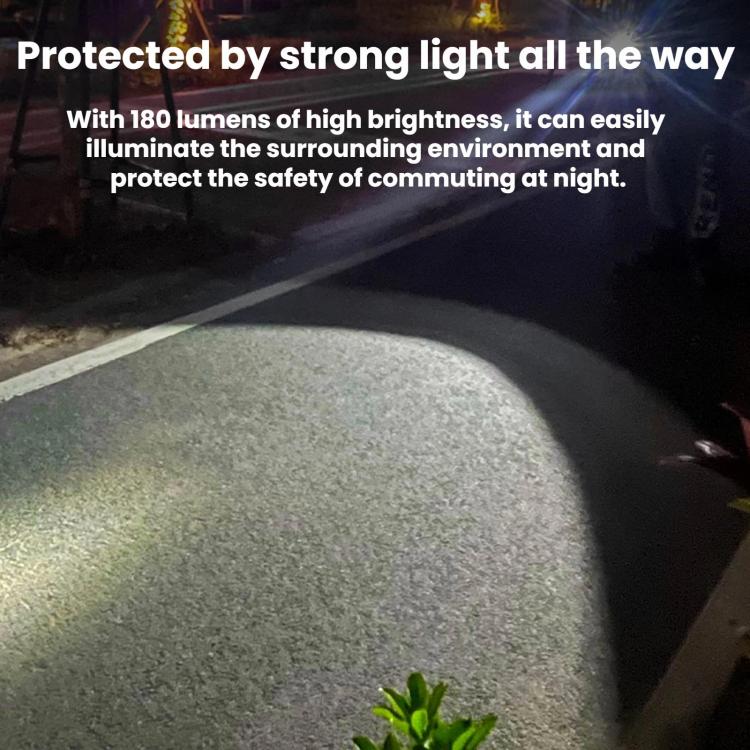 Mini rechargeable LED keychain flashlight shining a bright beam on the ground