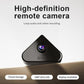 Black triangular indoor security camera with visible lens, on a tabletop