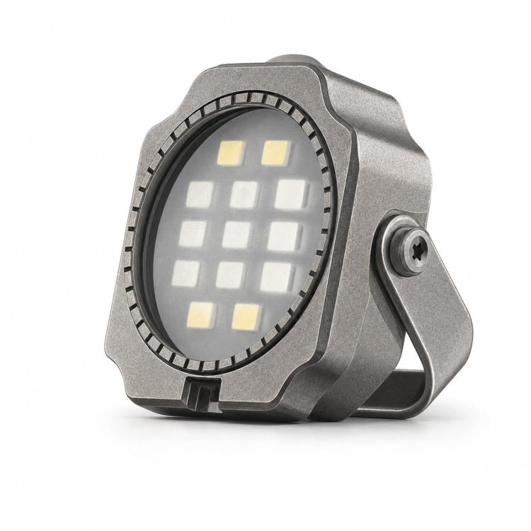 Gray mini LED flashlight with round light array and side clip, angled view