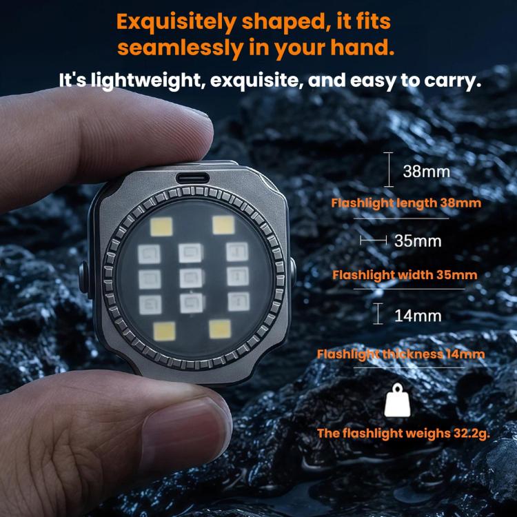 Mini round LED keychain flashlight held in hand with textured metal bezel