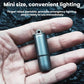 Mini keychain flashlight with top loop, dark metallic cylindrical body in open palm